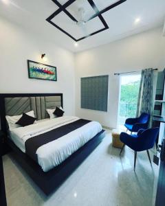 a bedroom with a large bed and a window at The Nines Hotel & Restro in Kālādhūngi +18 photos