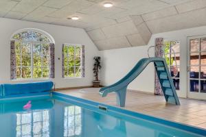 a swimming pool with a slide in the middle at Feriehus 2033 in Ulfborg
