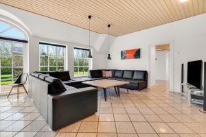 a living room with a couch and a table at Feriehus 2033 in Ulfborg