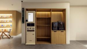 a room with a vending machine next to a shelf at Anook Hotel Ulsan Samsan in Ulsan