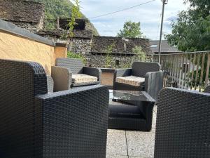 a group of wicker chairs and tables on a patio at Pancuc Charme & Relax in Gordevio +12 photos
