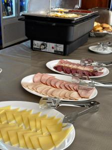 two plates of food on a table with meat and cheese at Casa Scriitorilor in Olimp +21 photos