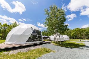 a couple of tents sitting on a wooden deck at GRAMPING STAY TOMAMU in Tomamu