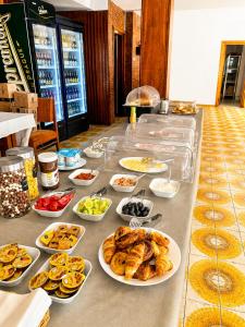 a buffet with many plates of food on a table at Casa Scriitorilor in Olimp