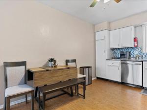 a kitchen with a table and chairs in a room at All About Alaska in Anchorage +14 photos