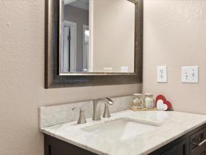 a bathroom with a sink and a mirror at All About Alaska in Anchorage