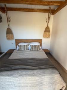 a bedroom with a large bed with two pillows at Villa Olympia with private pool in Antiparos