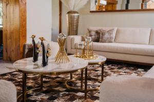 a living room with two tables and a couch at Hotel Dorys de Lourdes in Pisco Elqui