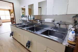 a kitchen counter with two sinks in a kitchen at GRAMPING STAY TOMAMU in Tomamu +178 photos
