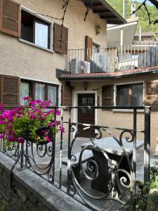 a wrought iron fence with flowers on a building at Pancuc Charme & Relax in Gordevio