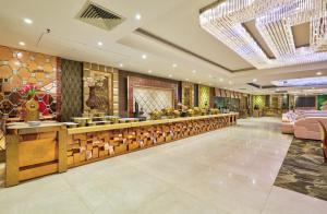 a lobby of a hotel with a counter and chairs at Hotel Royal Imporio Surajkund Faridabad in Faridabad