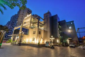 a large building at night with lights on at Hotel Royal Imporio Surajkund Faridabad in Faridabad