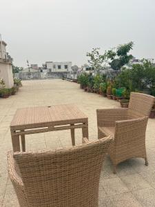 a picnic table and chairs on a patio at Nilayam guest house in Patna