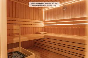 a sauna with wooden paneled walls and wooden floors at Trivrh Outdoor Hotel in Žirovnica