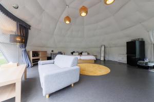 a large room with a bed and a couch and a table at GRAMPING STAY TOMAMU in Tomamu