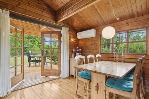 a wooden dining room with a table and chairs at Peaceful Holiday Home Close To Nature in Glesborg