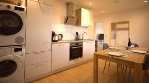 a kitchen with a table and a washing machine at Trüffelhof 2 in Bodman-Ludwigshafen