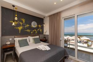 a bedroom with a bed and a view of the ocean at Ester Luxury Rooms in Skala Potamias +146 photos