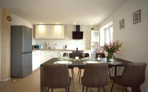 a kitchen with a table and chairs in a kitchen at Trüffelhof 1 in Bodman-Ludwigshafen