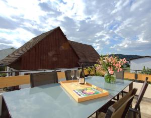 a table with a bottle of wine on a balcony at Trüffelhof 1 in Bodman-Ludwigshafen