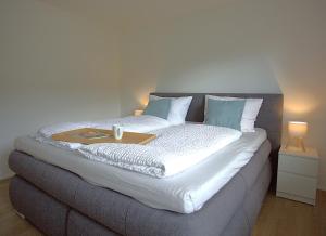 a large bed with a tray on top of it at Trüffelhof 1 in Bodman-Ludwigshafen