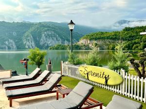 a group of lounge chairs with a view of a lake at Serenity in Eşelniţa