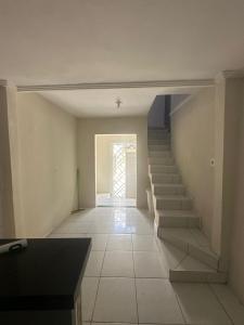 an empty hallway with stairs in a house at Residencial js in Fortaleza
