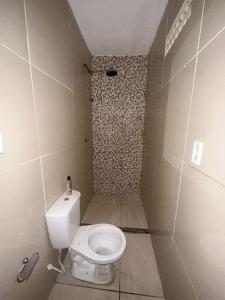 a small bathroom with a toilet and a shower at Residencial js in Fortaleza
