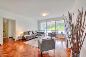 a living room with a couch and a table at Residenza Parco Carona with Lake-View - Happy Rentals in Lugano