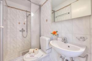 a bathroom with a sink and a toilet and a shower at Residenza Parco Carona with Lake-View - Happy Rentals in Lugano +33 photos