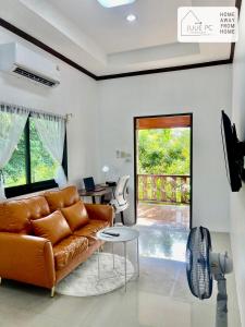 a living room with a couch and a table at Temple House by Julie PC in Ko Phangan