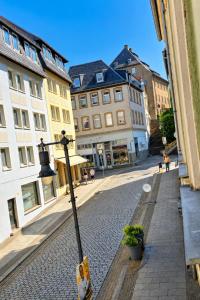 an empty street in a city with buildings at Gera Apartment Green in Gera