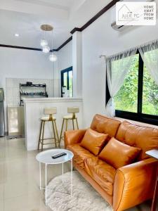a living room with a couch and a table at Temple House by Julie PC in Ko Phangan
