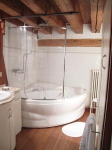 a white bath tub in a bathroom with a sink at Casa Carlo Goldoni in Venice