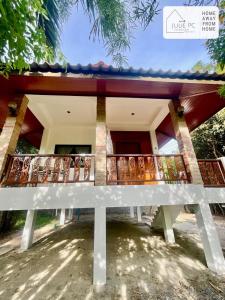 a white bench in front of a building at Temple House by Julie PC in Ko Phangan