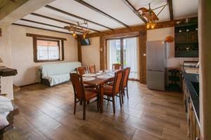 a dining room with a table and chairs and a kitchen at Klinwdzydze in Wdzydze Tucholskie