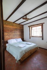 a bedroom with a large bed with a wooden headboard at Klinwdzydze in Wdzydze Tucholskie