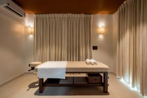 a bed in a room with a window at SAMA The Silver Creek in Bogmalo