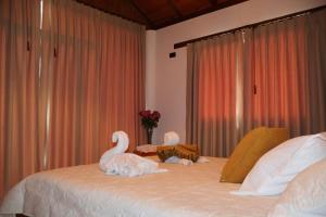 two stuffed swans sitting on top of a bed at LAS 7 CASCADAS Campground - Restaurant - Lodge in Cacaoal