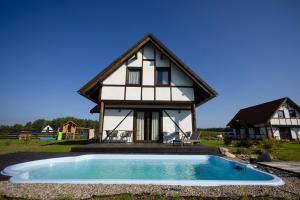 a house with a pool in front of it at Klinwdzydze in Wdzydze Tucholskie