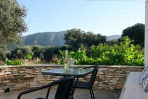 a table with a bottle of wine on a patio at Studios Margarita in Artemonas