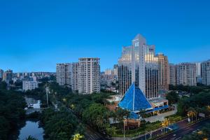 a city skyline with tall buildings and a blue pyramid at Wyndham Garden Haikou Meilan in Haikou