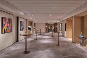 a gallery with several tables and paintings on the walls at Hyatt Centric Zhongshan Park Shanghai in Shanghai +101 photos