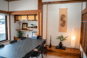 a dining room with a large table and chairs at The Alpen House Omachi in Omachi
