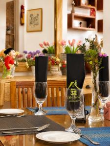 a table with wine glasses on top of it at Villa Lunka in Nuwara Eliya
