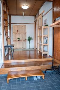 a room with a wooden floor and a bench at The Alpen House Omachi in Omachi +117 photos