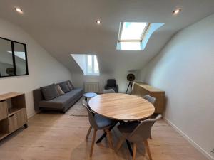 a living room with a table and a couch at vannes évasion in Vannes +5 photos