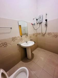 a bathroom with a toilet and a sink at Panda House in Galle