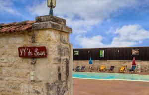 a sign on the side of a building next to a pool at Amazing Home In Lonnes With Heated Swimming Pool in Lonnes