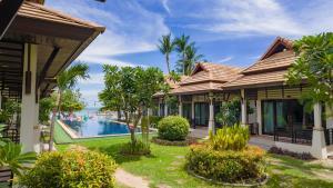 a resort with a pool and palm trees at Poolsawat Villa - SHA Plus in Lamai